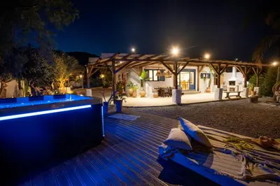 a bench sitting on a deck at night at Ninémia Sea living in Archangelos