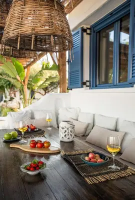 a table with plates of food and glasses of wine at Ninémia Sea living in Archangelos