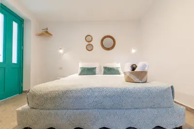 a bedroom with a large bed with a basket on it at Casa Ifestou in Rhodes Town
