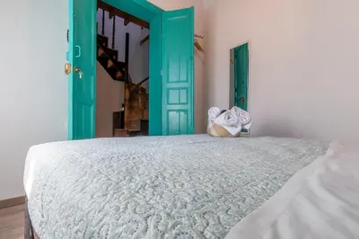 a bedroom with a bed and a green door at Casa Ifestou in Rhodes Town