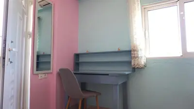a chair in a room with a desk and a mirror at Summer scoop studio by EvaGstays in Faliraki