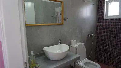 a bathroom with a sink and a toilet and a mirror at Summer scoop studio by EvaGstays in Faliraki