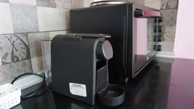 a microwave sitting on top of a counter next to aether at Summer scoop studio by EvaGstays in Faliraki