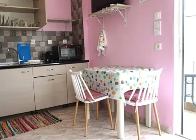 a kitchen with a table and two chairs at Summer scoop studio by EvaGstays in Faliraki