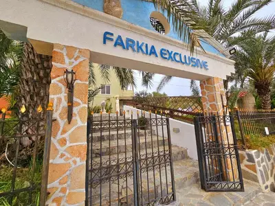 a gate in front of a building with a sign at Farkia Studios by Aegean in Faliraki