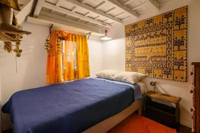 a bedroom with a blue bed and a window at Casa Aletta - Old Town Apt. in Rhodes Town