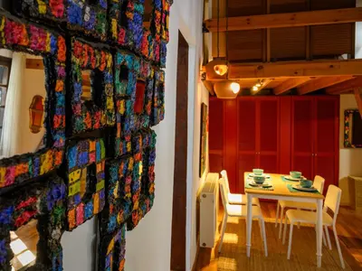 a dining room with a table and chairs and a wall at Casa Aletta - Old Town Apt. in Rhodes Town
