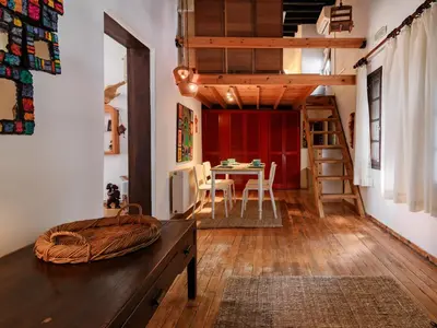 a living room with a table and a loft at Casa Aletta - Old Town Apt. in Rhodes Town