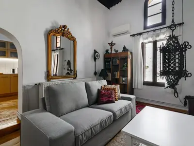 a living room with a couch and a mirror at Casa Aletta - Old Town Apt. in Rhodes Town