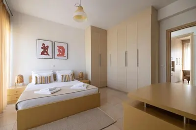 a bedroom with a bed with a desk and a table at Villa Serenity in Ialyssos