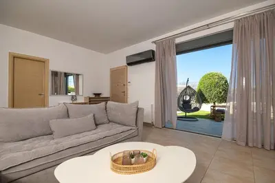 a living room with a couch and a large window at Villa Serenity in Ialyssos