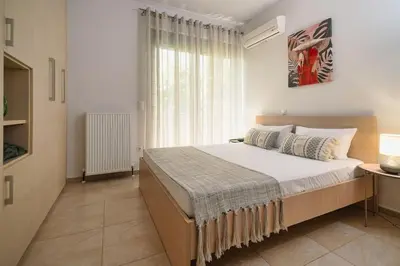 a bedroom with a large bed and a window at Villa Serenity in Ialyssos