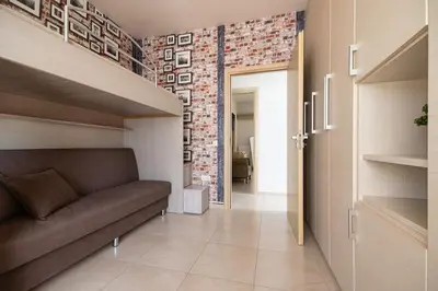 a living room with a couch and a brick wall at Villa Serenity in Ialyssos