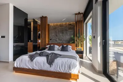a bedroom with a large bed and a large window at The Suite in Rhodes Town