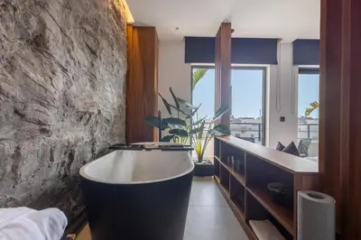 a bathroom with a bath tub in a room at The Suite in Rhodes Town