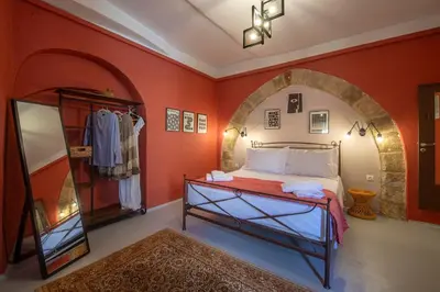 a bedroom with a bed and an arched doorway at Old Town Corner Luxury Studios in Rhodes Town