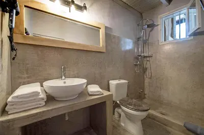 a bathroom with a sink and a toilet and a mirror at Old Town Corner Luxury Studios in Rhodes Town