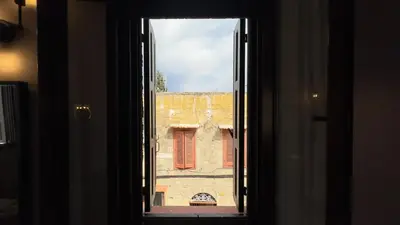 an open window with a view of a building at Old Town Corner Luxury Studios in Rhodes Town