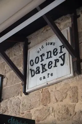 a sign on the side of a brick wall at Old Town Corner Luxury Studios in Rhodes Town