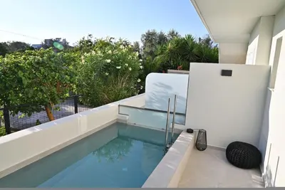 a swimming pool on the balcony of a house at Rhotheon Suites in Ialysos Rhodes - private pool in selected rooms in Ialyssos