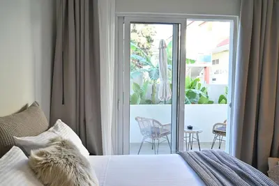 a bedroom with a bed and a sliding glass door at Rhotheon Suites in Ialysos Rhodes - private pool in selected rooms in Ialyssos