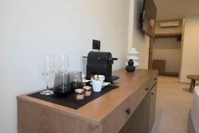 a counter with wine glasses and a coffee maker at Rhotheon Suites in Ialysos Rhodes - private pool in selected rooms in Ialyssos