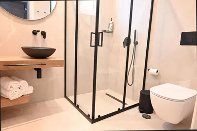 a bathroom with a shower and a toilet at Rhotheon Suites in Ialysos Rhodes - private pool in selected rooms in Ialyssos