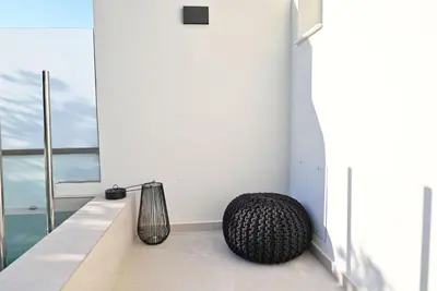 a vase sitting on a counter next to a window at Rhotheon Suites in Ialysos Rhodes - private pool in selected rooms in Ialyssos