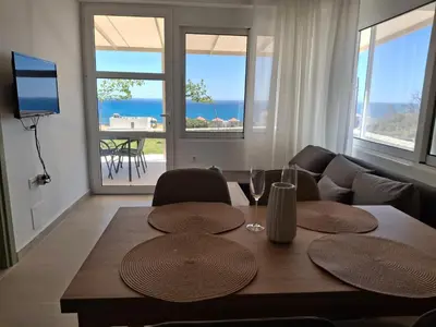 a living room with a table and a couch at Almira Beach House in Kiotari
