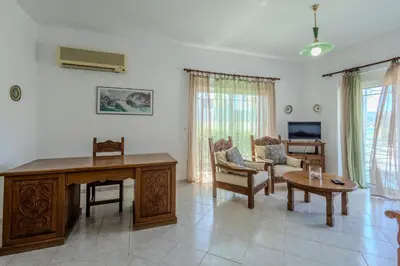 a living room with a desk and a couch at STEGNA REA Seaside Apartment in Archangelos