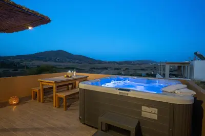 a jacuzzi tub on the roof of a house at Asimenis Cottages in Kattavía