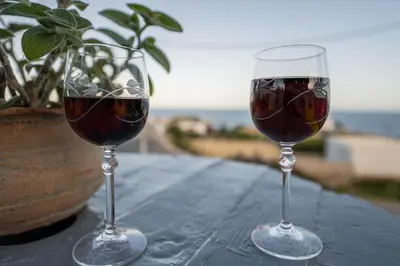 two glasses of wine sitting on top of a table at Aegean Sunrise View in Archangelos