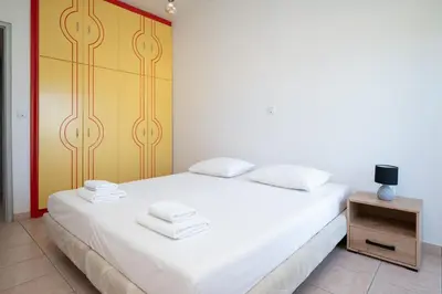a bedroom with a white bed and a night stand at Berry apartment in Ixia