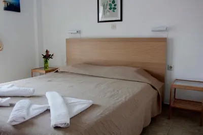a bedroom with a bed with two towels on it at Milios Studios in Megálon Choríon