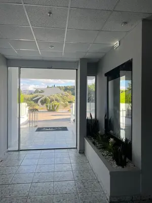 an empty hallway of a building with a view of a patio at Ayit Hotel in Theologos