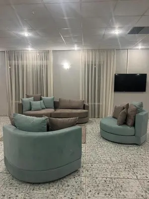 a living room with two couches and a flat screen tv at Ayit Hotel in Theologos