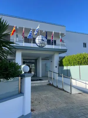 a building with american flags on top of it at Ayit Hotel in Theologos