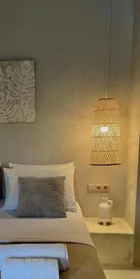 a bedroom with a bed with a light and a lamp at Hacienda tradition&relax in Afantou