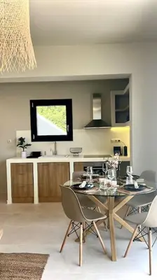 a dining room with a table and chairs in a kitchen at Hacienda tradition&relax in Afantou