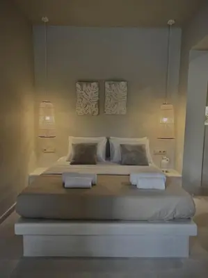 a bedroom with a large bed with two pillows at Hacienda tradition&relax in Afantou