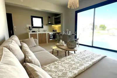 a living room with a white couch and a table at Hacienda tradition&relax in Afantou