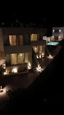 a building with a swimming pool at night at Hacienda tradition&relax in Afantou