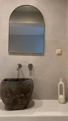 a bathroom with a large stone bowl and a mirror at Hacienda tradition&relax in Afantou