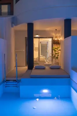 a room with a bed with blue lights on it at The Palms Concept Hotel Adults Only 16 Plus in Faliraki
