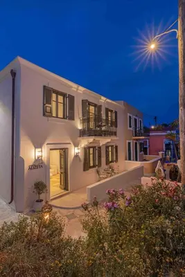 a large white building with aigiligil sign on it at Casa Alizeta in Halki