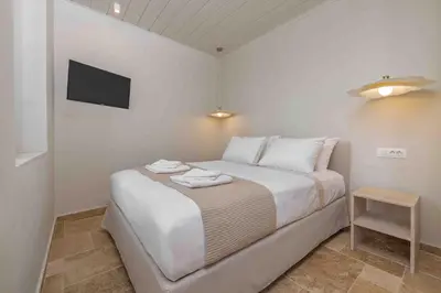 a bedroom with a bed with two towels on it at Casa Alizeta in Halki