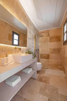 a bathroom with a sink and a tub and a toilet at Casa Alizeta in Halki
