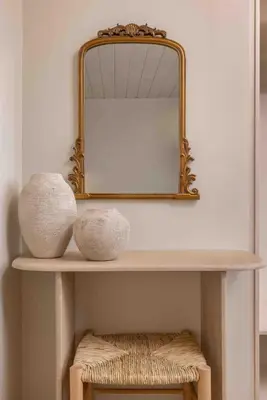 a mirror on top of a shelf with two vases at Casa Alizeta in Halki