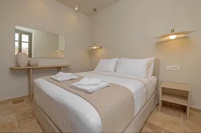 a bedroom with a large bed with towels on it at Casa Alizeta in Halki