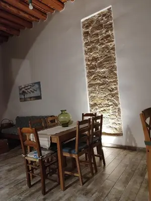 a dining room with a wooden table and chairs at Flora's Traditional House in Malona Village